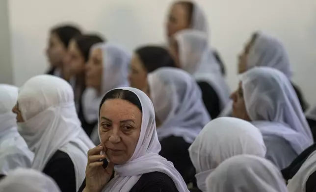 Women from the Israeli Druze minority mourn during the funeral of Israeli Colonel Ehsan Daxa in Daliyat al-Carmel, Israel, Monday, Oct. 21, 2024. Daxa, 41, was killed during Israel's ground operation in the Gaza Strip, where the Israeli army has been battling Palestinian militants in the war ignited by Hamas' Oct. 7 2023 attack into Israel. (AP Photo/Ariel Schalit)