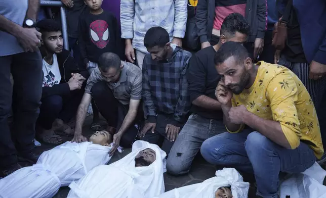 Palestinians mourn their relatives killed in the Israeli bombardment of the Gaza Strip at a hospital morgue in Deir al-Balah, Tuesday, Oct. 29, 2024. (AP Photo/Abdel Kareem Hana)