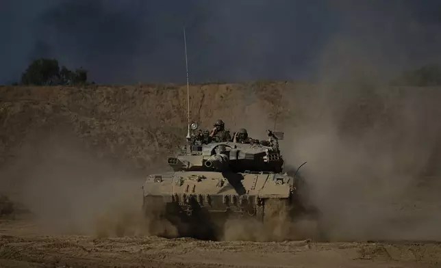 An Israeli army tank maneuvers near the Israel-Gaza border in southern Israel, Sunday, Oct. 20, 2024. (AP Photo/Tsafrir Abayov)