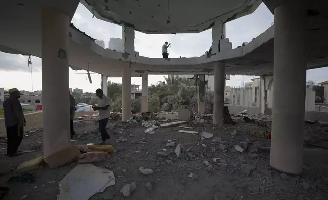 Palestinians examine a destroyed mosque following an Israeli airstrike in Deir al-Balah, Sunday, Oct. 6, 2024. (AP Photo/Abdel Kareem Hana)