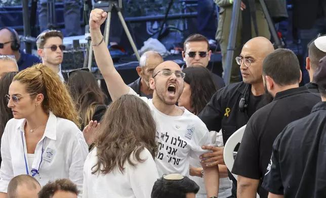 A man shouts as Israeli Prime Minister Benjamin Netanyahu speaks during a ceremony marking the Hebrew calendar anniversary of the Hamas attack on October 7 last year, at the Mount Herzl military cemetery in Jerusalem, Israel Sunday Oct. 27, 2024. (Gil Cohen-Magen/Pool Photo via AP)