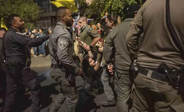 Police disperse people protesting against Prime Minister Benjamin Netanyahu's government and calling for the release of hostages held in the Gaza Strip by the Hamas militant group, near the Prime Minister's residence in Jerusalem, Monday, Oct. 28, 2024. (AP Photo/Ohad Zwigenberg)