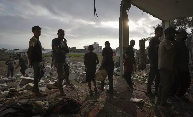 Palestinians examine a destroyed mosque following an Israeli airstrike in Deir al-Balah, Sunday, Oct. 6, 2024. (AP Photo/Abdel Kareem Hana)