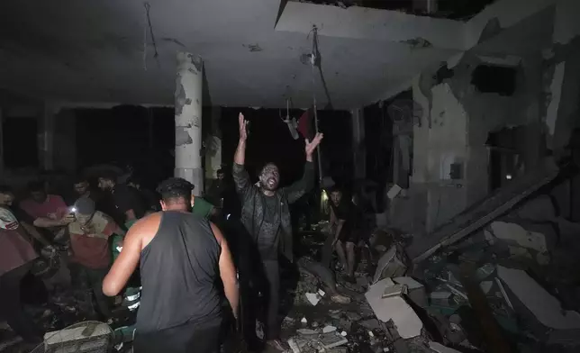 Palestinians search for survivors and bodies in the rubble of a mosque destroyed in an Israeli airstrike in Deir al-Balah, Sunday, Oct. 6, 2024. (AP Photo/Abdel Kareem Hana)