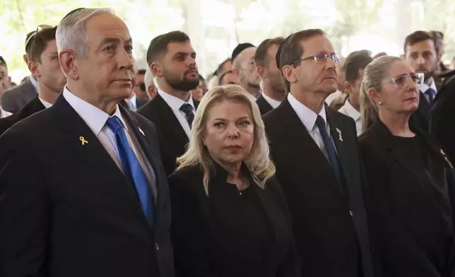 Israel's Prime Minister Benjamin Netanyahu, from left, his wife Sara Netanyahu, President Isaac Herzog and First Lady Michal Herzog, attend a ceremony marking the Hebrew calendar anniversary of the Hamas attack on October 7 last year, at the Mount Herzl military cemetery in Jerusalem, Israel Sunday Oct. 27, 2024. (Gil Cohen-Magen/Pool Photo via AP)