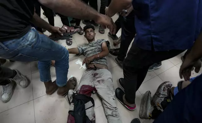 A Palestinian wounded in the Israeli bombardment of the Gaza Strip is treated in a hospital in Deir al Balah, Saturday, Oct. 19, 2024. (AP Photo/Abdel Kareem Hana)