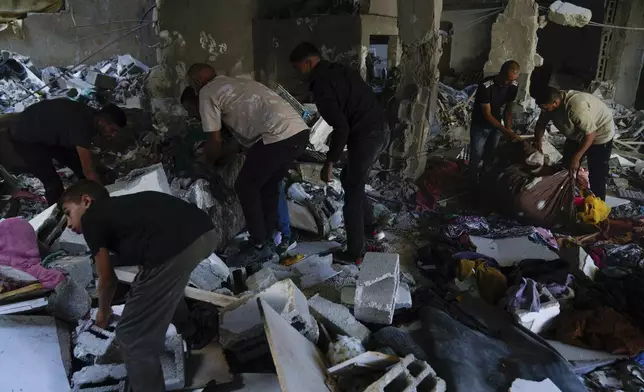 Palestinians examine the damage following an Israeli airstrike in the West Bank city of Tulkarem, which Palestinian health officials say killed 18 people and the Israeli military says took out a Hamas leader, on Friday, Oct. 4, 2024. (AP Photo/Nasser Nasser)