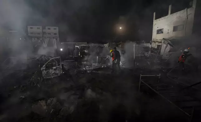 Palestinian firefighters try to extinguish a fire caused by an Israeli strike that hit a tent area in the courtyard of Al Aqsa Martyrs hospital in Deir al Balah, Gaza Strip, Monday, Oct. 14, 2024. (AP Photo/Abdel Kareem Hana)