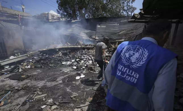 FILE - Palestinians look at the destruction after an Israeli strike on a school run by UNRWA, the U.N. agency helping Palestinian refugees, in Nuseirat, Gaza Strip, May 14, 2024. (AP Photo/Abdel Kareem Hana, File)