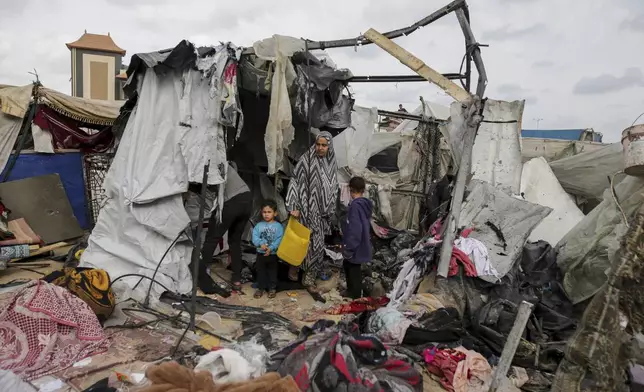 FILE - Displaced Palestinians inspect their tents destroyed by Israel's bombardment, adjunct to an UNRWA facility west of Rafah city, Gaza Strip, Tuesday, May 28, 2024. (AP Photo/Jehad Alshrafi, File)