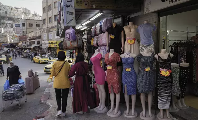 Palestinian women shop at the commercial center of the West Bank city of Nablus Saturday, Sept. 14, 2024. (AP Photo/Nasser Nasser)