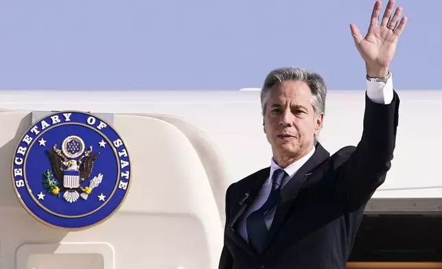 U.S. Secretary of State Antony Blinken waves as he departs for Riyadh, Saudi Arabia, from Ben Gurion International Airport in Tel Aviv, Israel, Wednesday, Oct. 23, 2024. (Nathan Howard/Pool Photo via AP)