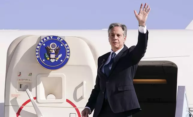 U.S. Secretary of State Antony Blinken waves as he departs for Riyadh, Saudi Arabia, from Ben Gurion International Airport in Tel Aviv, Israel, Wednesday, Oct. 23, 2024. (Nathan Howard/Pool Photo via AP)