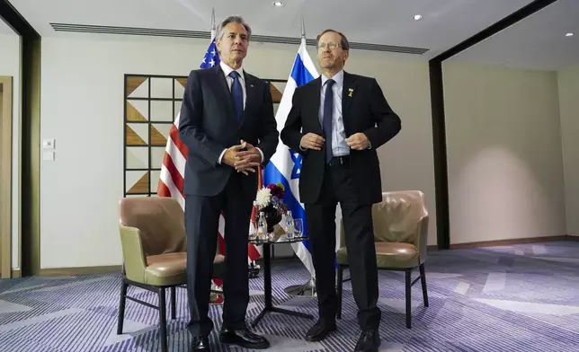 U.S. Secretary of State Antony Blinken, left, meets with Israel's President Isaac Herzog in Tel Aviv, Tuesday, Oct. 22, 2024. (Nathan Howard/Pool via AP)