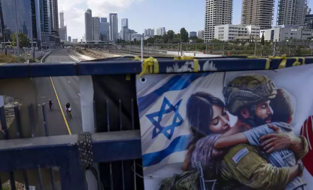 Cyclists ride on a car-free highway during the Jewish holiday of Yom Kippur in Tel Aviv, Israel, on Saturday, Oct. 12, 2024. (AP Photo/Oded Balilty)