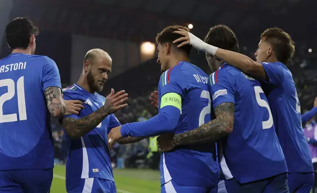 Italian's Giovanni di Lorenzo celebrates with teammates after scoring his side's second goal during the UEFA Nations League soccer match between Italia and Israel at the Bluenergy Stadium in Udine, Italy, Monday, Oct. 14, 2024. (Andrea Bressanutti/LaPresse via AP)