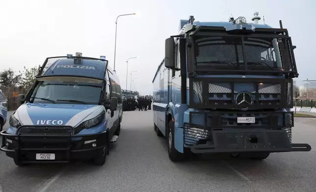 Police vehicles patrol the area of the Bluenergy stadium ahead of the Nations League soccer match between Italy and Israel, in Udine, Italy, Monday, Oct. 14, 2024. (Andrea Bressanutti/LaPresse via AP)