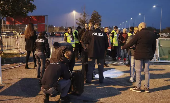 Spectators go through security checks ahead of the Nations League soccer match between Italy and Israel, at the Bluenergy stadium in Udine, Italy, Monday, Oct. 14, 2024. (Andrea Bressanutti/LaPresse via AP)