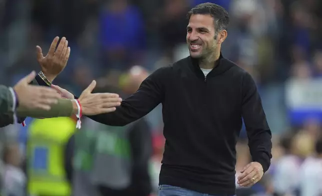 Como's Cesc Fabregas is congratulated following the Serie A soccer match between Atalanta and Como at the Gewiss Stadium in Bergamo, Italy, Tuesday, Sept. 24 , 2024. (Spada/LaPresse via AP)