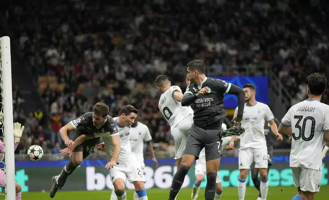 AC Milan's Christian Pulisic, not seen, scores direct from the corner his side's first goal during the Champions League opening phase soccer match between AC Milan and Club Brugge at the San Siro stadium in Milan, Italy, Tuesday, Oct. 22, 2024. (AP Photo/Antonio Calani)