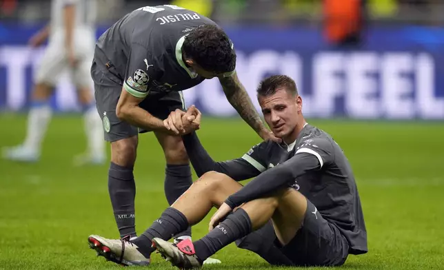 AC Milan's Francesco Camarda, bottom, reacts after the Champions League opening phase soccer match between AC Milan and Club Brugge at the San Siro stadium in Milan, Italy, Tuesday, Oct. 22, 2024. (AP Photo/Antonio Calani)