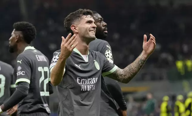 AC Milan's Christian Pulisic reacts after scoring the opening goal of his team during the Champions League opening phase soccer match between AC Milan and Club Brugge at the San Siro stadium in Milan, Italy, Tuesday, Oct. 22, 2024. (AP Photo/Antonio Calani)