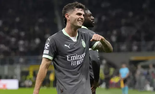 AC Milan's Christian Pulisic reacts after scoring the opening goal of his team during the Champions League opening phase soccer match between AC Milan and Club Brugge at the San Siro stadium in Milan, Italy, Tuesday, Oct. 22, 2024. (AP Photo/Antonio Calani)