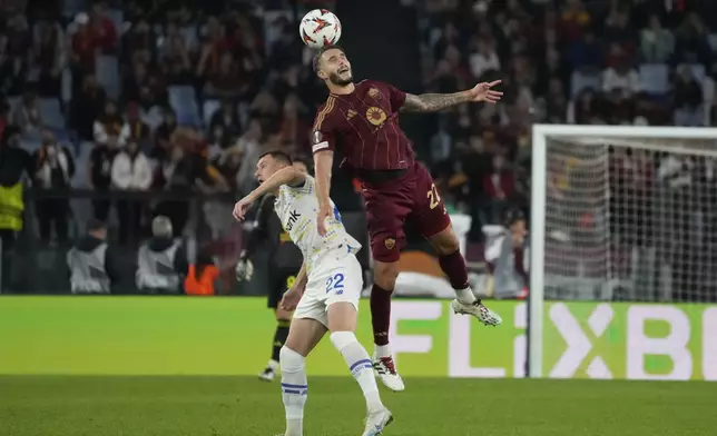 Roma's Mario Hermoso goes for the header with Dynamo Kyiv's Vladyslav Kabayev during the Europa League opening phase soccer match between Roma and Dinamo Kyiv at the Olympic Stadium, in Rome, Thursday, Oct. 24, 2024. (AP Photo/Gregorio Borgia)