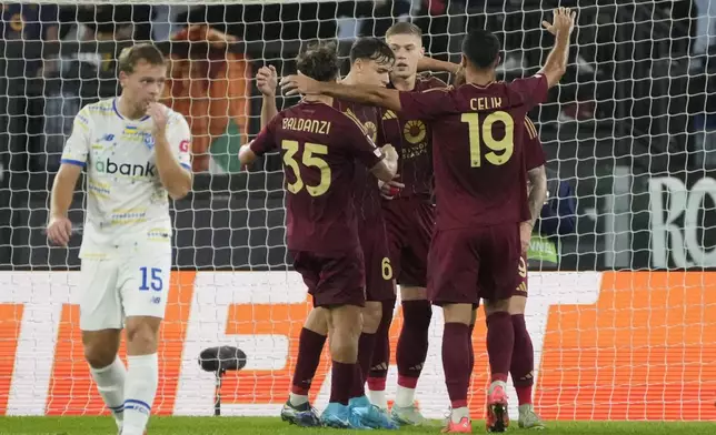 Roma's Artem Dovbyk celebrates with teammates after scoring his side's first goal during the Europa League opening phase soccer match between Roma and Dinamo Kyiv at the Olympic Stadium, in Rome, Thursday, Oct. 24, 2024. (AP Photo/Gregorio Borgia)