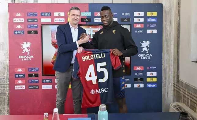 Mario Balotelli and Genoa sports director Marco Ottolini pose with Balotelli's jersey in Genoa, Italy, Monday, Oct. 28, 2024. (Tano Pecoraro/LaPresse via AP)