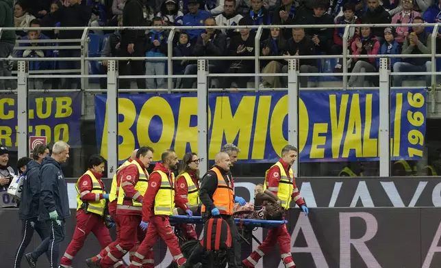 Torino's Duvan Zapata is carried off the pitch after being injured during the Serie A soccer match between Inter Milan and Torino at the San Siro Stadium, in Milan, Italy, Saturday, Oct. 5, 2024. (AP Photo/Antonio Calanni)