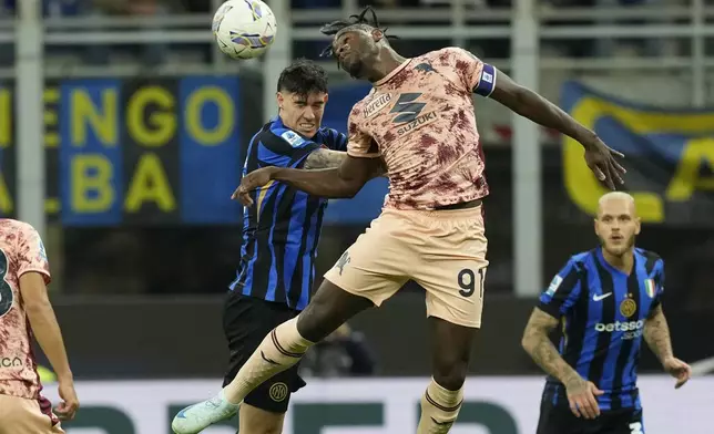 Torino's Duvan Zapata, center, jumps for the ball during the Serie A soccer match between Inter Milan and Torino at the San Siro Stadium, in Milan, Italy, Saturday, Oct. 5, 2024. (AP Photo/Antonio Calanni)