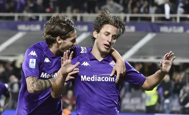 Fiorentina's Edoardo Bove, right, celebrates after scoring a goal during the Italian Serie A soccer match between Fiorentina and Roma at the Stadio Artemio Franchi in Florence, Italy, Sunday, Oct. 27, 2024. (LaPresse via AP)