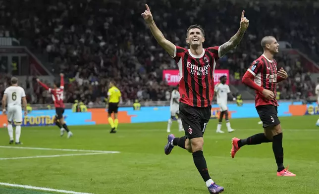 AC Milan's Christian Pulisic celebrates after he scored during the Serie A soccer match between AC Milan and Lecce at the San Siro stadium in Milan, Italy, Friday, Sept. 27, 2024. (AP Photo/Antonio Calanni)