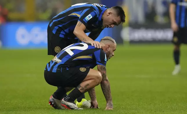 Inter Milan's Lautaro Martinez, top, talks to Inter Milan's Federico Dimarco during a Serie A soccer match between Inter Milan and Juventus at the San Siro stadium in Milan, Italy, Sunday, Oct. 27, 2024. (AP Photo/Luca Bruno)