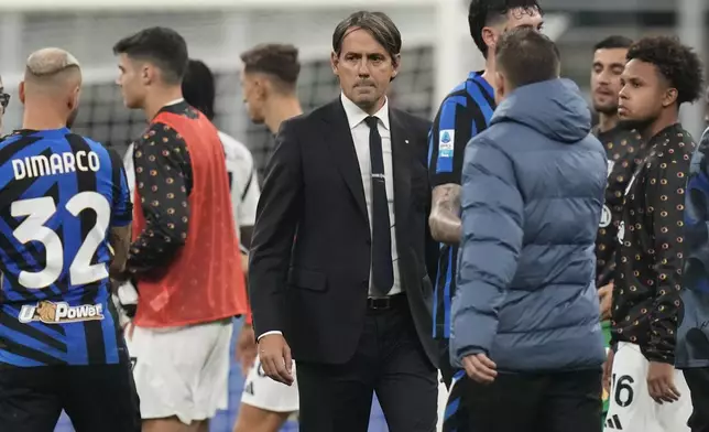 Inter Milan's head coach Simone Inzaghi, center, looks dejected after a Serie A soccer match between Inter Milan and Juventus at the San Siro stadium in Milan, Italy, Sunday, Oct. 27, 2024. (AP Photo/Luca Bruno)