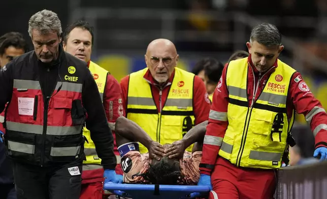 Torino's Duvan Zapata is carried off the field following an injury during the Serie A soccer match between Inter Milan and Torino at the San Siro Stadium, in Milan, Italy, Saturday, Oct. 5, 2024. (Fabio Ferrari/LaPresse via AP)