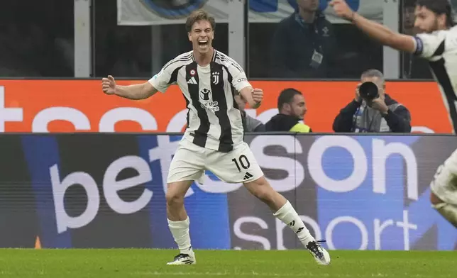 Juventus' Kenan Yildiz, left, celebrates after scoring his side's fourth goal during a Serie A soccer match between Inter Milan and Juventus at the San Siro stadium in Milan, Italy, Sunday, Oct. 27, 2024. (AP Photo/Luca Bruno)