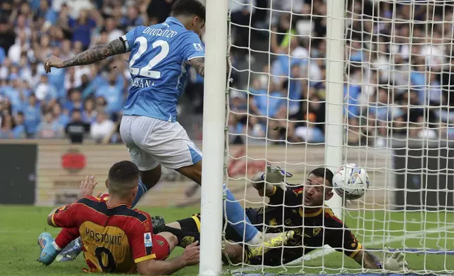 Napoli's Giovanni Di Lorenzo, centre, scores the opening goal during the Serie A soccer match between Napoli and Lecce at the Diego Armando Maradona Stadium in Naples, Italy, Saturday, Oct. 26, 2024. (Alessandro Garofalo/LaPresse via AP)