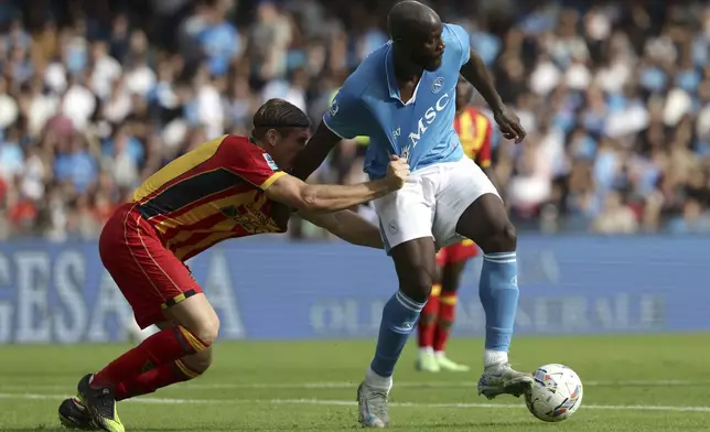 Lecce's Federico Baschirotto, left, and Napoli's Romelu Lukaku challenge for the ball during the Serie A soccer match between Napoli and Lecce at the Diego Armando Maradona Stadium in Naples, Italy, Saturday, Oct. 26, 2024. (Alessandro Garofalo/LaPresse via AP)