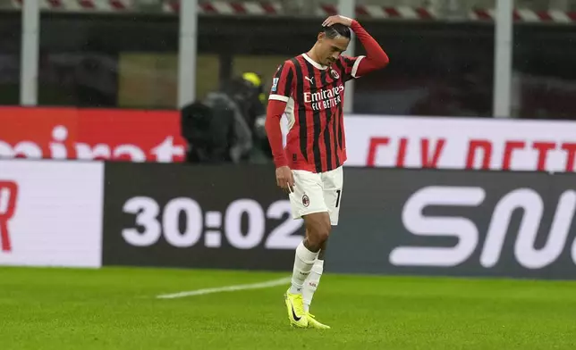 AC Milan's Tijjani Reijnders leaves the pitch after receiving the red card during the Serie A soccer match between AC Milan and Udinese at the San Siro Stadium, in Milan, Italy, Saturday, Oct. 19, 2024. (AP Photo/Antonio Calanni)