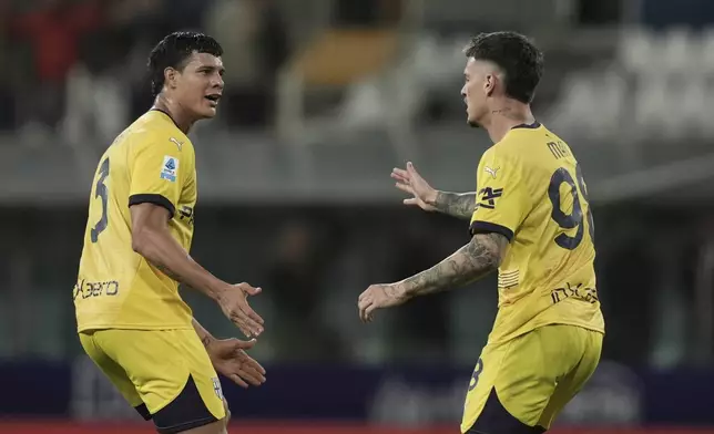 Parma's Dennis Man, right, celebrates with Yordan Osorio after scoring his side's first goal during the Serie A soccer match between Parma and Cagliari in Parma, Italy, Monday, Sept. 30, 2024 (Massimo Paolone/LaPresse via AP)