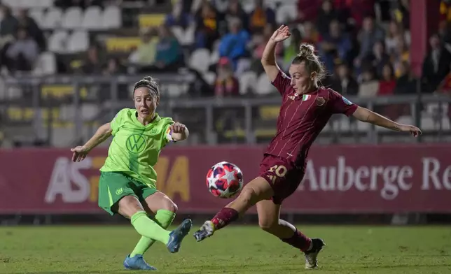 Wolfsburg's Svenja Huth , left, kicks the ball past Roma's Giada Greggi during the women's Champions League Group A soccer match between Roma and Wolfsburg at the Tre Fontane stadium in Rome, Tuesday, Oct. 8, 2024. (Fabrizio Corradetti/LaPresse via AP)