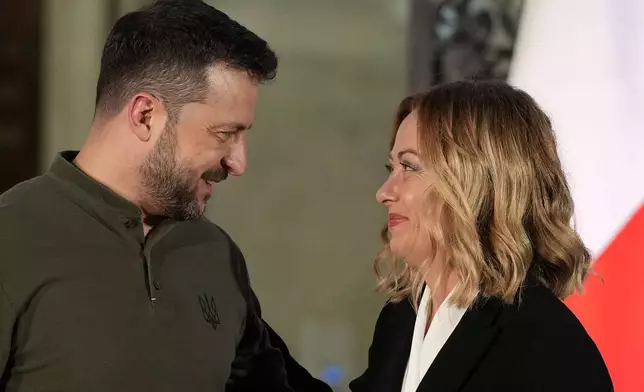 Italian Premier Giorgia Meloni, right, smiles with Ukrainian President Volodymyr Zelenskyy after the press conference, at Villa Pamphilj, in Rome, Thursday, Oct. 10, 2024. (AP Photo/Andrew Medichini)