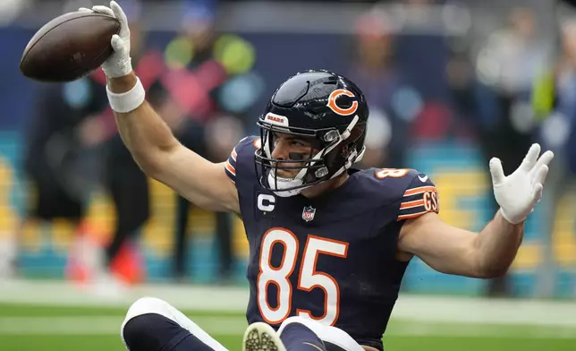 Chicago Bears tight end Cole Kmet (85) celebrates after scoring the first touch down in the first quarter of an NFL football game at the Tottenham Hotspur stadium between the Jacksonville Jaguars and Chicago Bears in London, Sunday, Oct. 13, 2024. (AP Photo/Alastair Grant)