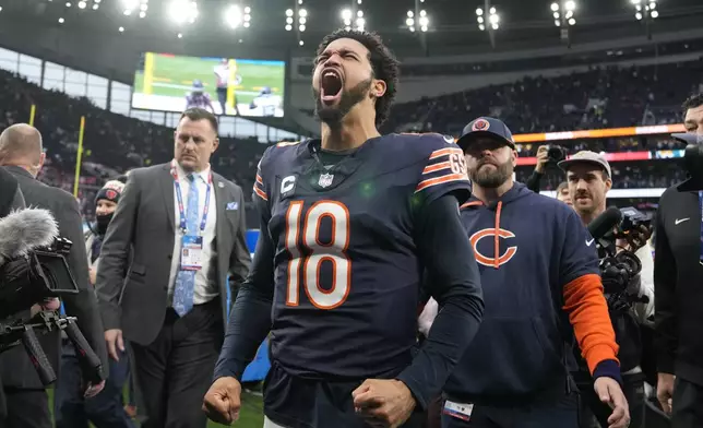 Chicago Bears quarterback Caleb Williams (18) reacts as he leaves the field after an NFL football game at the Tottenham Hotspur stadium between the Jacksonville Jaguars and Chicago Bears in London, Sunday, Oct. 13, 2024. (AP Photo/Alastair Grant)