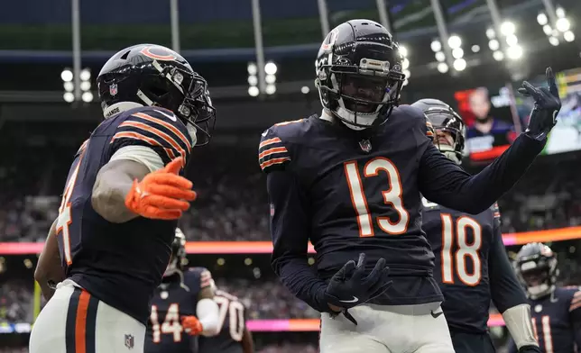 Chicago Bears wide receiver Keenan Allen (13), right, celebrates scoring a touchdown during the fourth quarter of an NFL football game at the Tottenham Hotspur stadium between the Jacksonville Jaguars and Chicago Bears in London, Sunday, Oct. 13, 2024.(AP Photo/Steve Luciano)