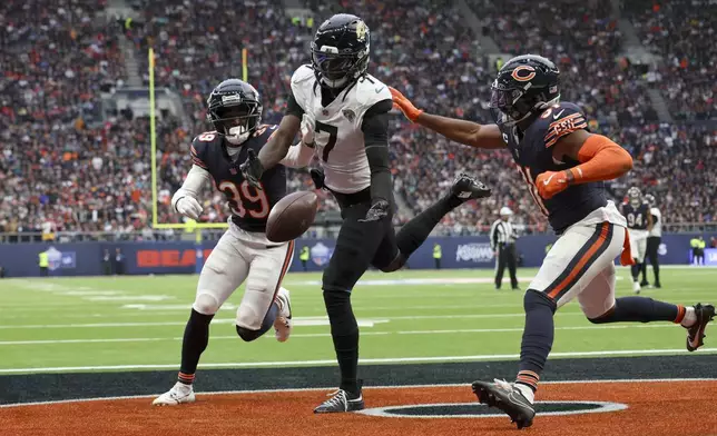 Jacksonville Jaguars wide receiver Brian Thomas Jr. (7) spills the ball in the end zone and fails to score during an NFL football game at the Tottenham Hotspur stadium between the Jacksonville Jaguars and Chicago Bears in London, Sunday, Oct. 13, 2024. (AP Photo/Ian Walton)