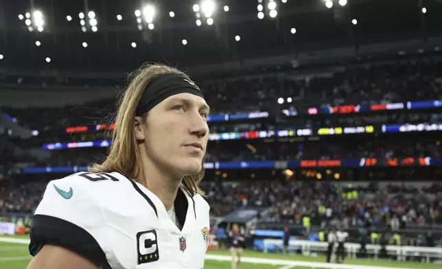 Jacksonville Jaguars quarterback Trevor Lawrence (16) leaves the field after an NFL football game at the Tottenham Hotspur stadium between the Jacksonville Jaguars and Chicago Bears in London, Sunday, Oct. 13, 2024. (AP Photo/Ian Walton)