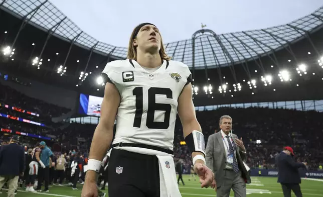 Jacksonville Jaguars quarterback Trevor Lawrence (16) leaves the field after an NFL football game at the Tottenham Hotspur stadium between the Jacksonville Jaguars and Chicago Bears in London, Sunday, Oct. 13, 2024. (AP Photo/Ian Walton)